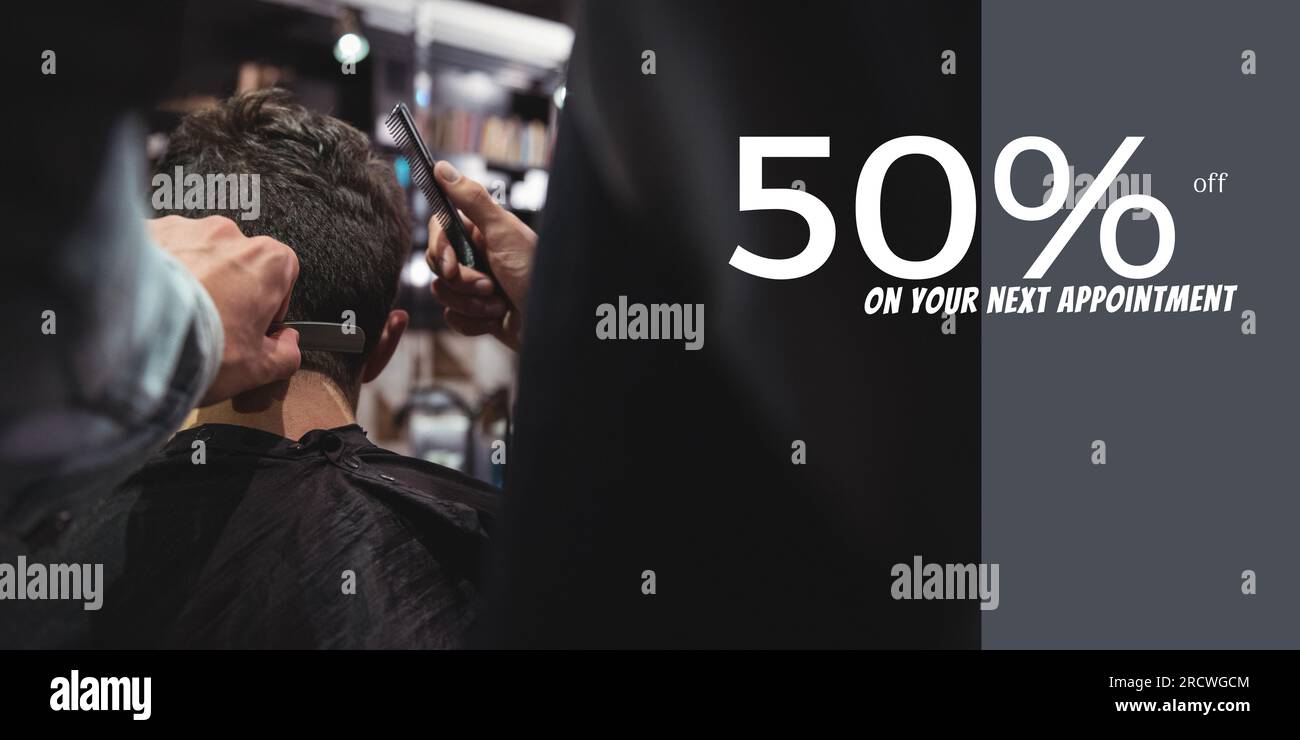 50 percent off text with diverse male client and male hairdresser cutting hair Stock Photo