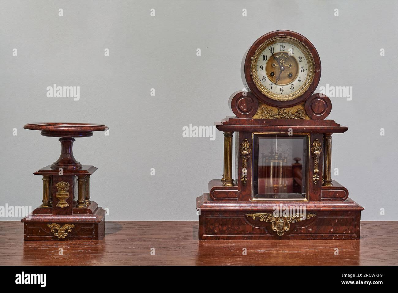 Antique clock with stand. Traditional table pendulum clock with wood