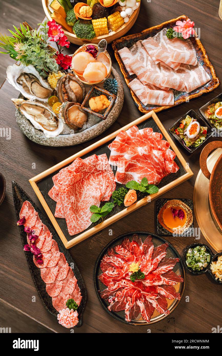 Seafood cuisine plate and beef sliced meat for hot pots. pork slices, scallops,  seashells, oysters, caviar and other seafood delicacies. Stock Photo