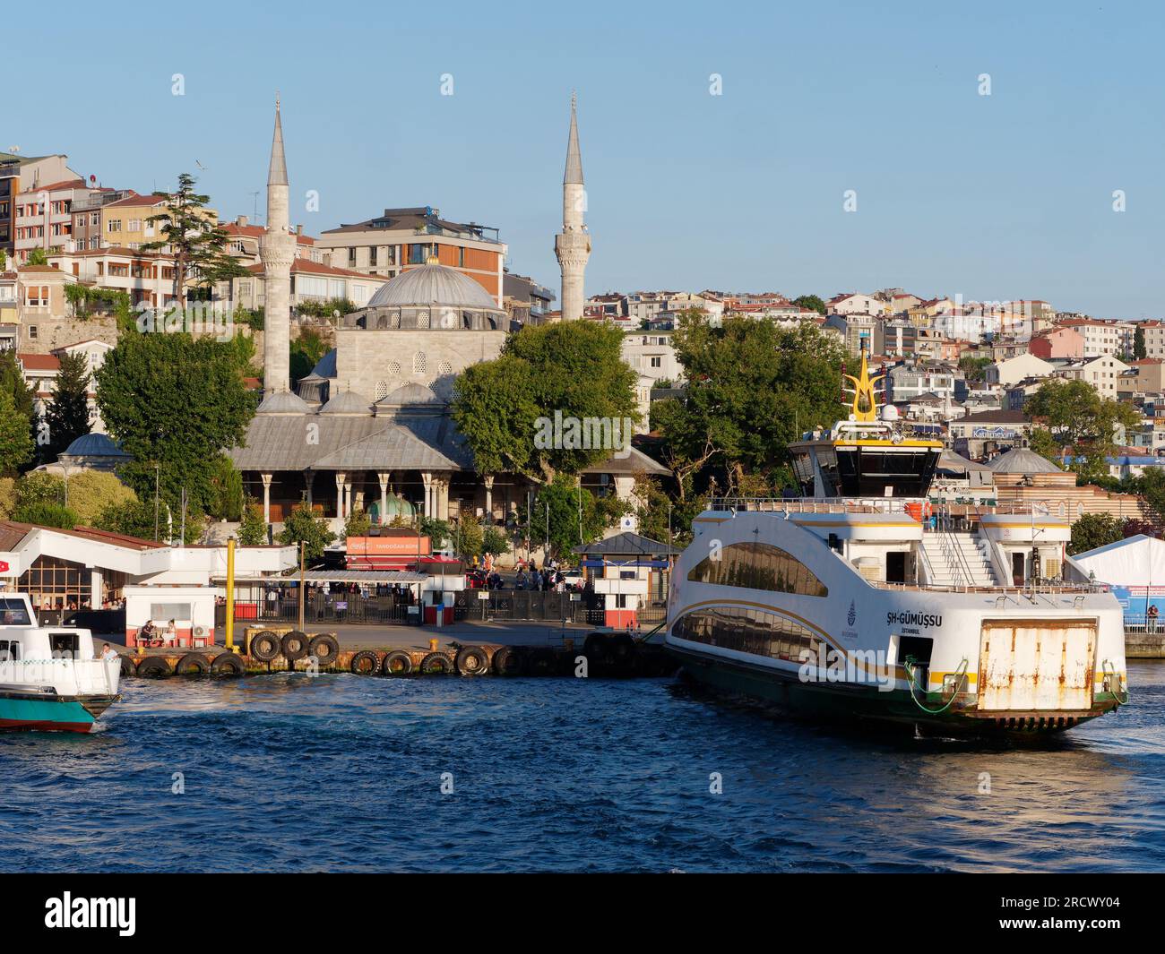 Passenger ferry docked at Uskudar on the Bosporus with the Mihrimah Sultan Mosque behind. Asian side of Istanbul, Turkey Stock Photo