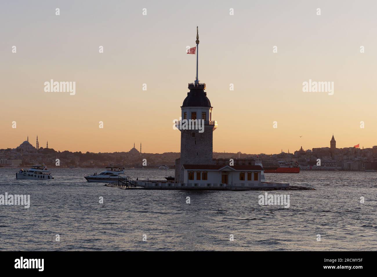 Summer sunset over the Bosporus Sea and Maidens Tower from Uskudar, Istanbul, Turkey, with the western side of the city behind. Stock Photo