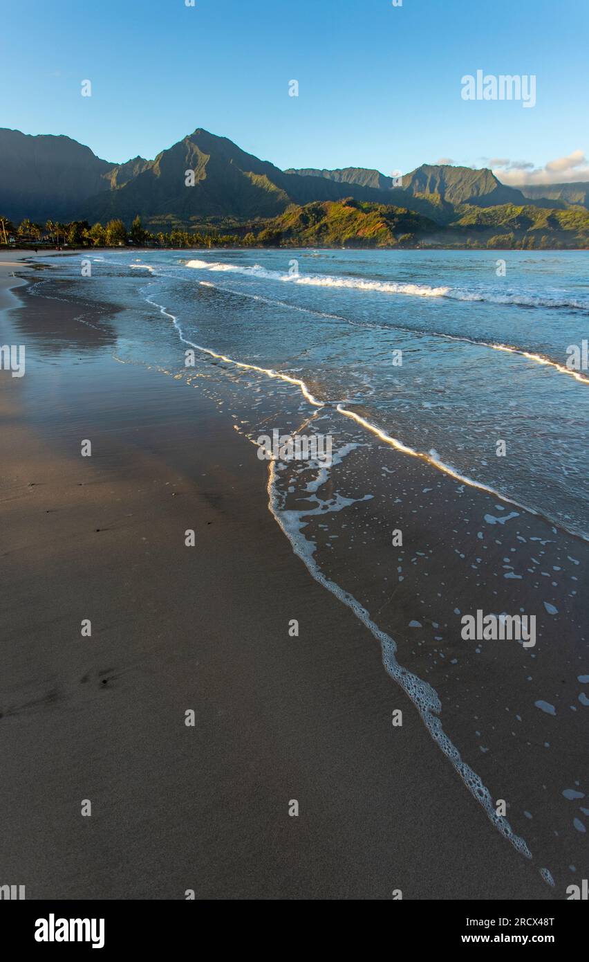 Waves gently lap beach, Hanalei Bay, Kauai Stock Photo
