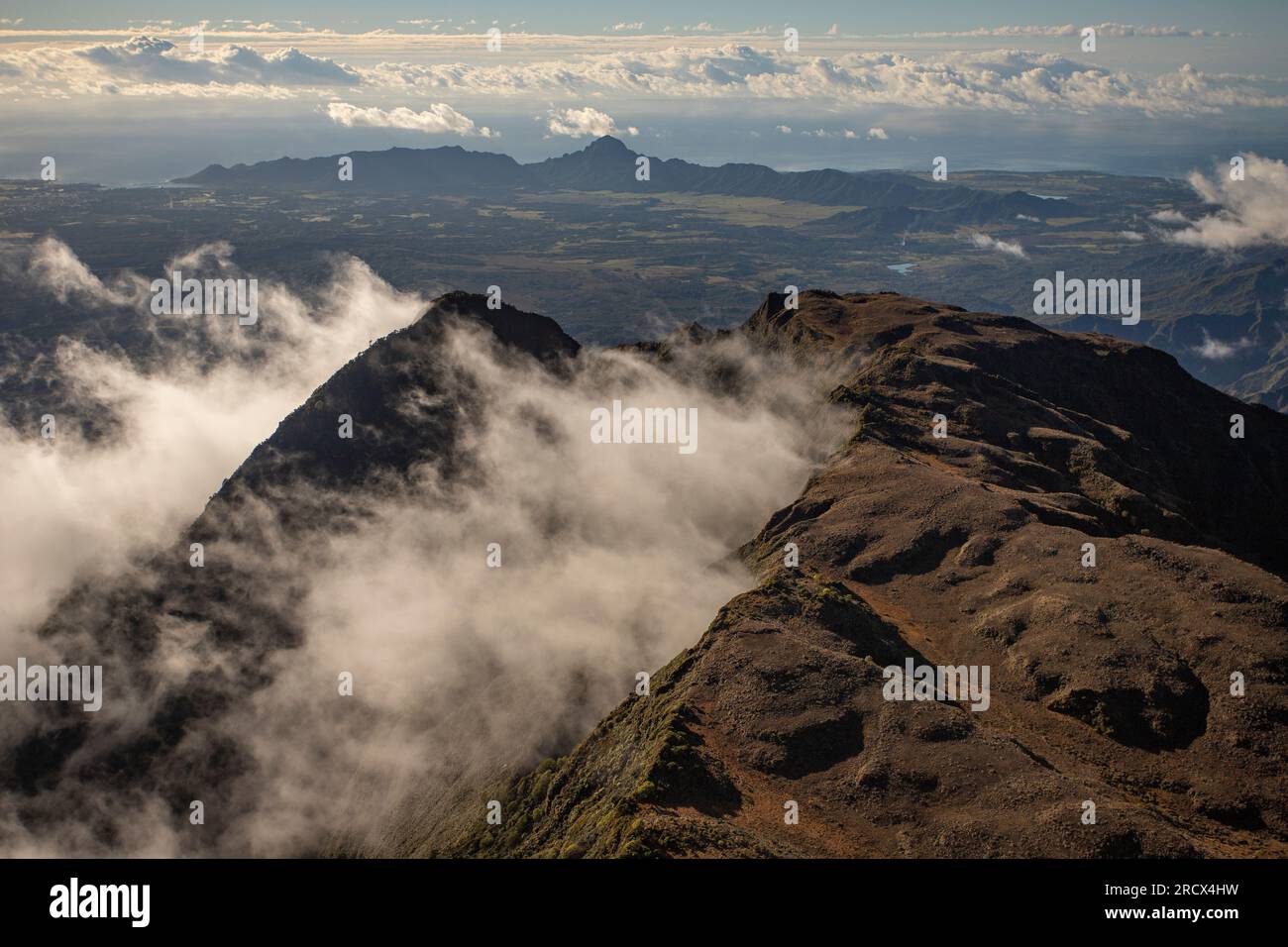 Clouds swirling around mountains of Kauai as seen from Helicopter Stock Photo