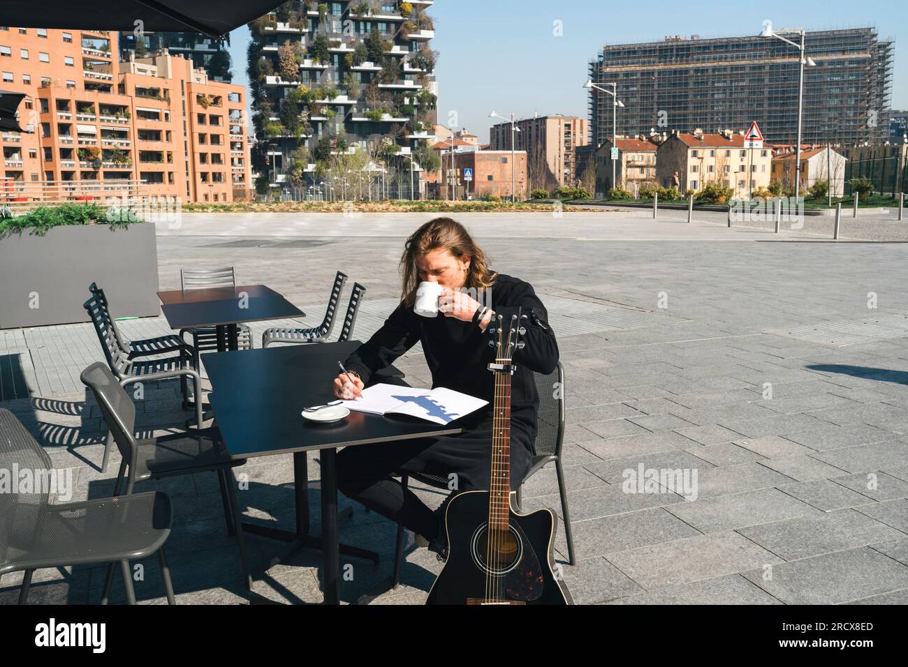 man taking a break drinking coffee in a sunny day Stock Photo