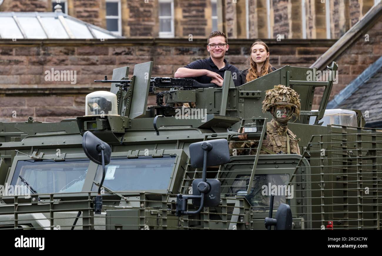 Redford Barracks, Edinburgh, Scotland, UK, 17 July 2023. Army at the Fringe: Performers of a show at Edinburgh Festival Fringe cast members of CTRL Room (about the role of AI in warfare) with soldiers in jungle camouflage of 3rd Battalion rifles with a huge heavily armoured Mastiff vehicle designed to counter threats from roadside bombs. Credit: Sally Anderson/Alamy Live News Stock Photo