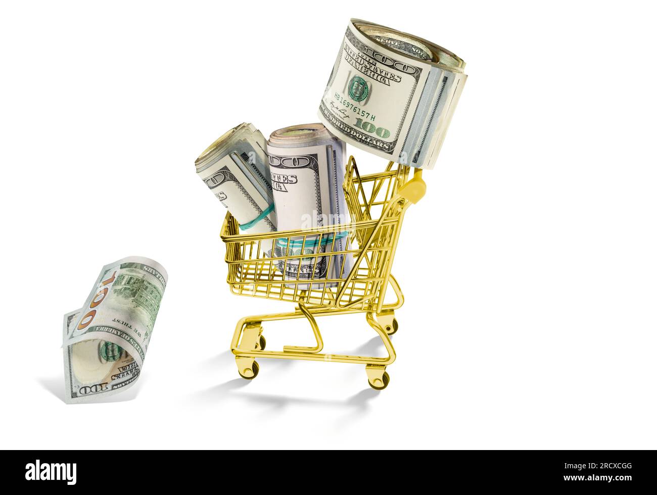 Savings and shopping expenses. Rolls of money, hundreds of dollars, in a golden basket, on a white background. Hundreds of bucks in cash. Stock Photo