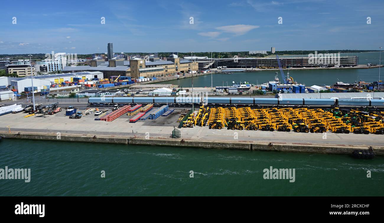 A car carrier train and yellow JCB's on the quayside at Southampton docks. Stock Photo