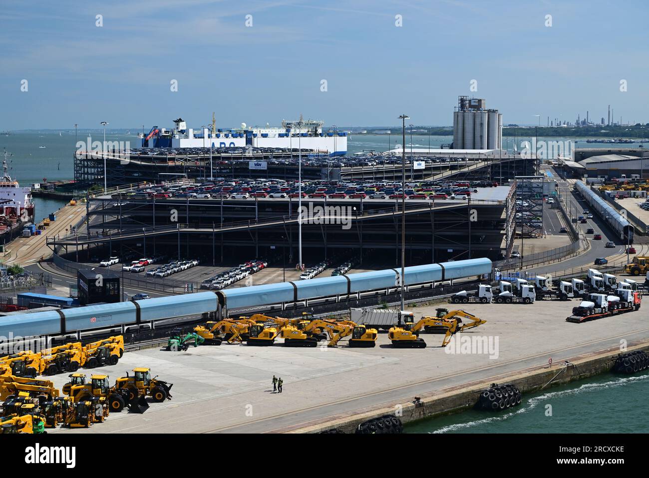 A car carrier train and yellow JCB's on the quayside at Southampton docks. Stock Photo