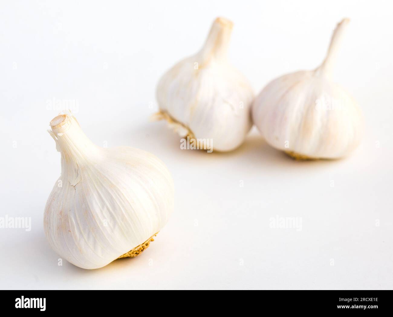 garlic heads and cloves on white background Stock Photo - Alamy
