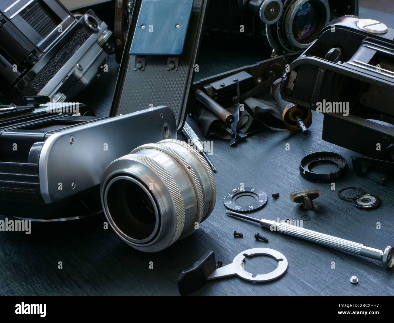 Close-up of old film cameras dismantled for repair. Stock Photo