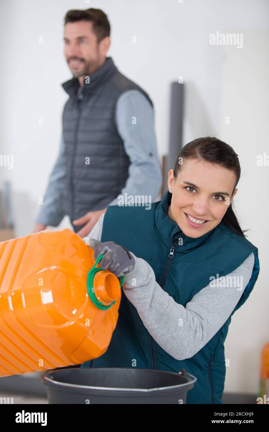woman transfers liquid into a container Stock Photo Alamy