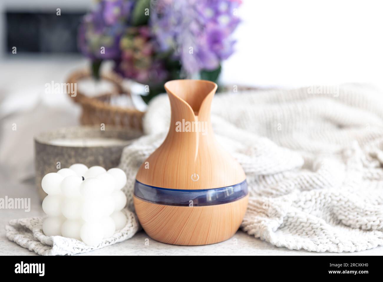 Spa composition with aroma oil diffuser lamp and candle on a blurred background. Stock Photo