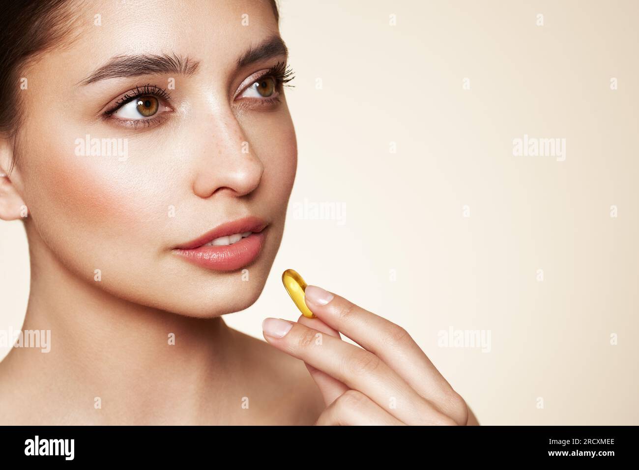 Vitamins. Close Up Of Happy Beautiful Girl With Pill With Cod Liver Oil