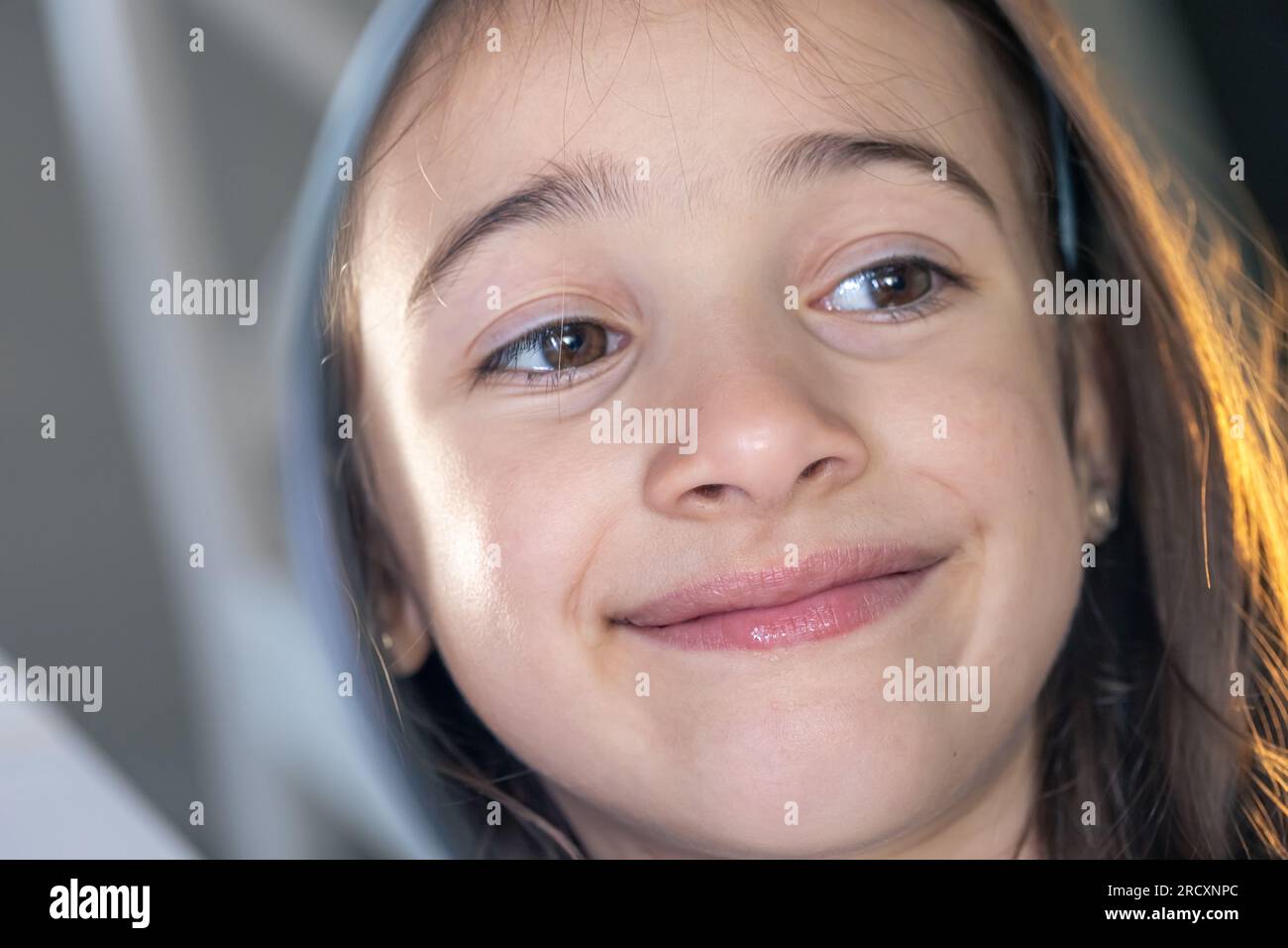 A teenage girl looks thoughtfully at her reflection in the mirror Stock ...