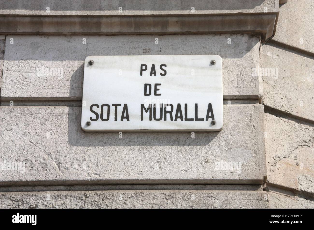 Street sign in Barcelona city, Spain. Pas De Sota Muralla. Stock Photo