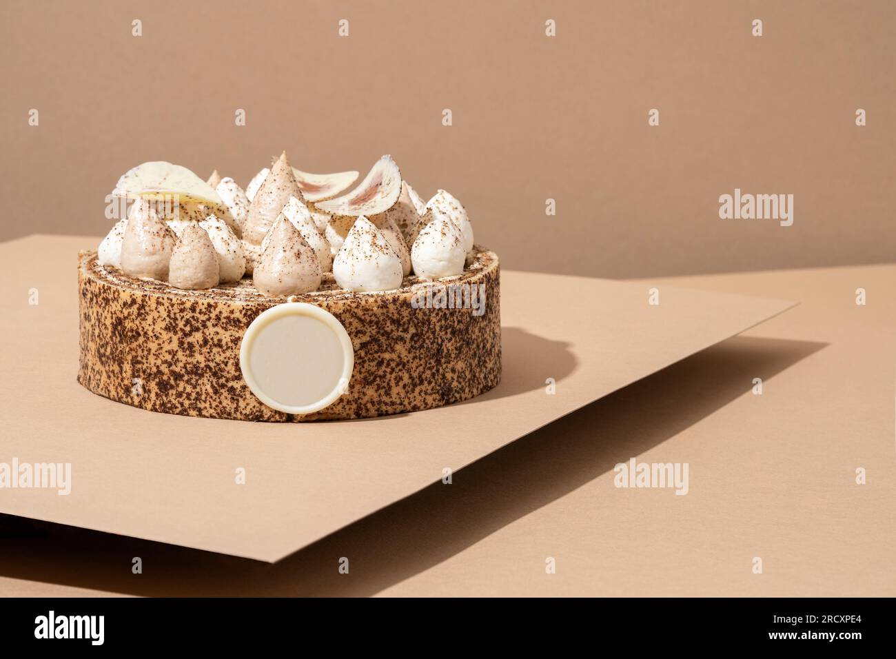 A scrumptious desert plate featuring a meringue desert, served on a cardboard plate and topped with cream Stock Photo