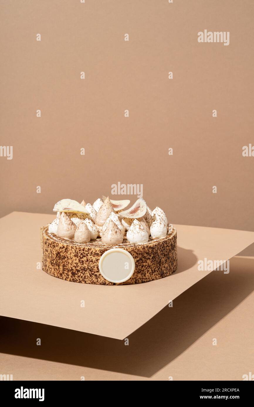 A scrumptious desert plate featuring a meringue desert, served on a cardboard plate and topped with cream Stock Photo