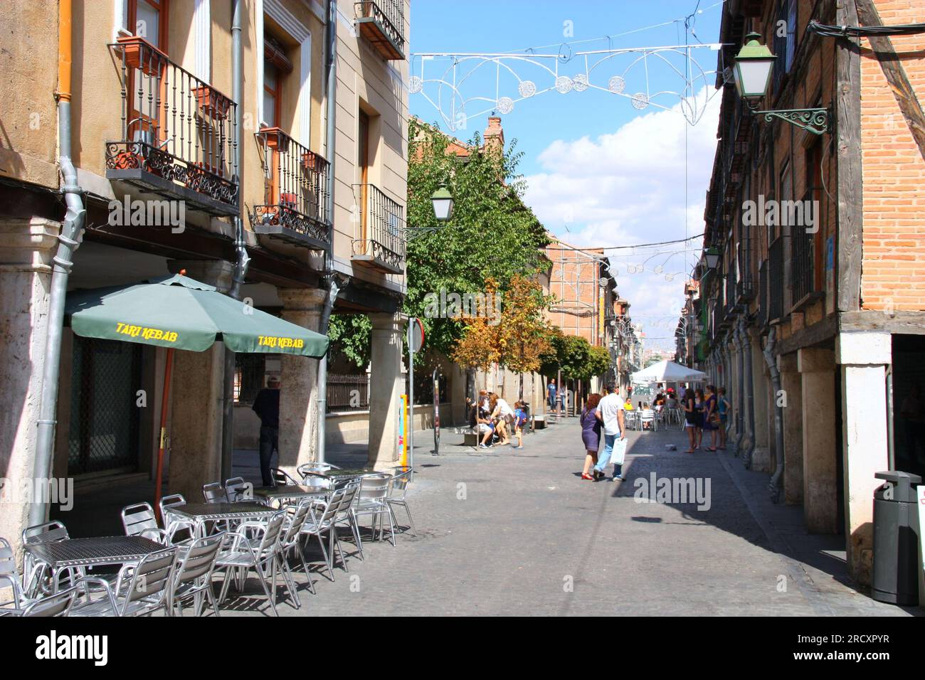 ALCALA DE HENARES, SPAIN - SEPTEMBER 5, 2009: People visit Calle Mayor street in Alcala de Henares in Spain. Stock Photo