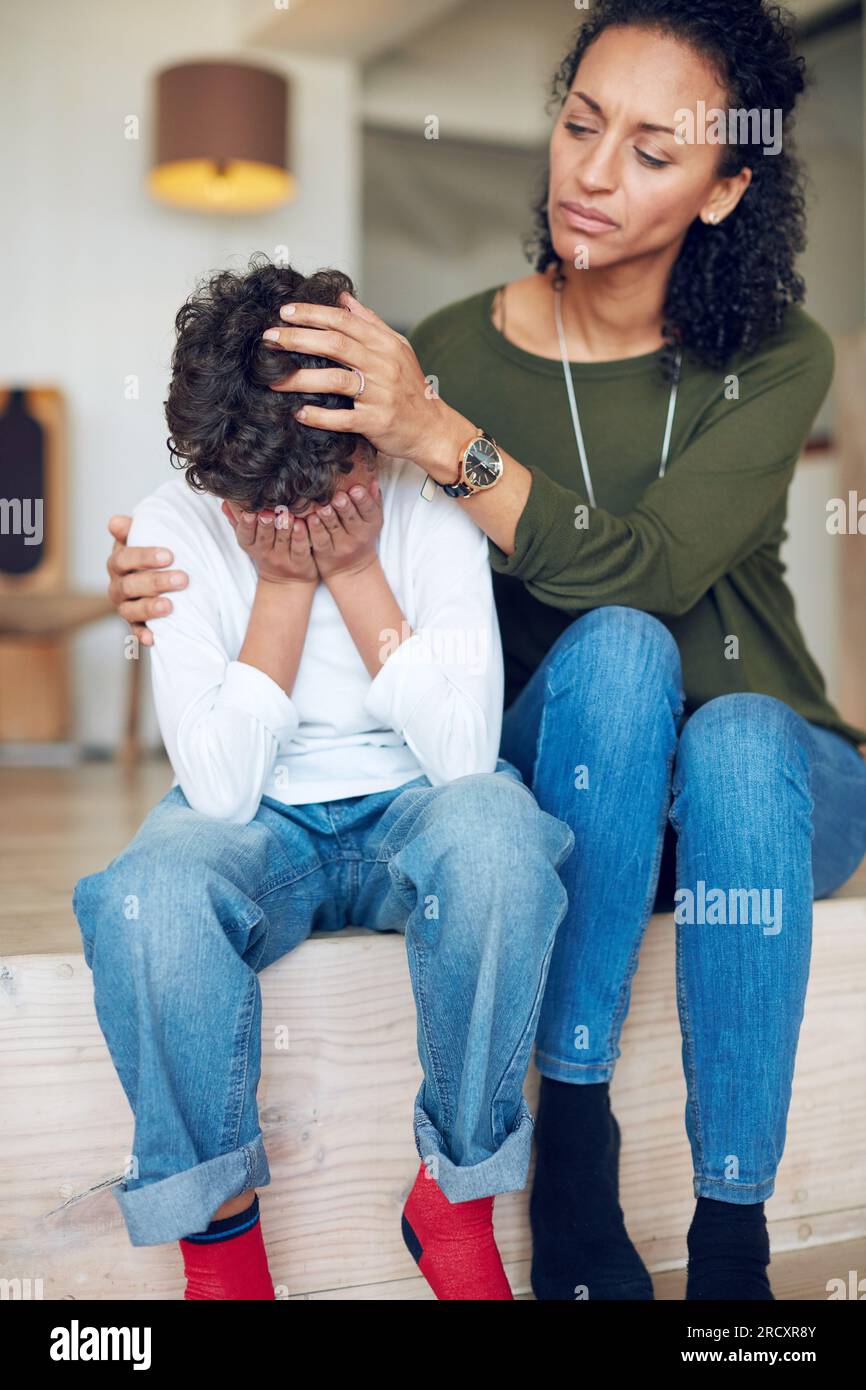Sad, depression and a mother with crying child together in stairs for ...