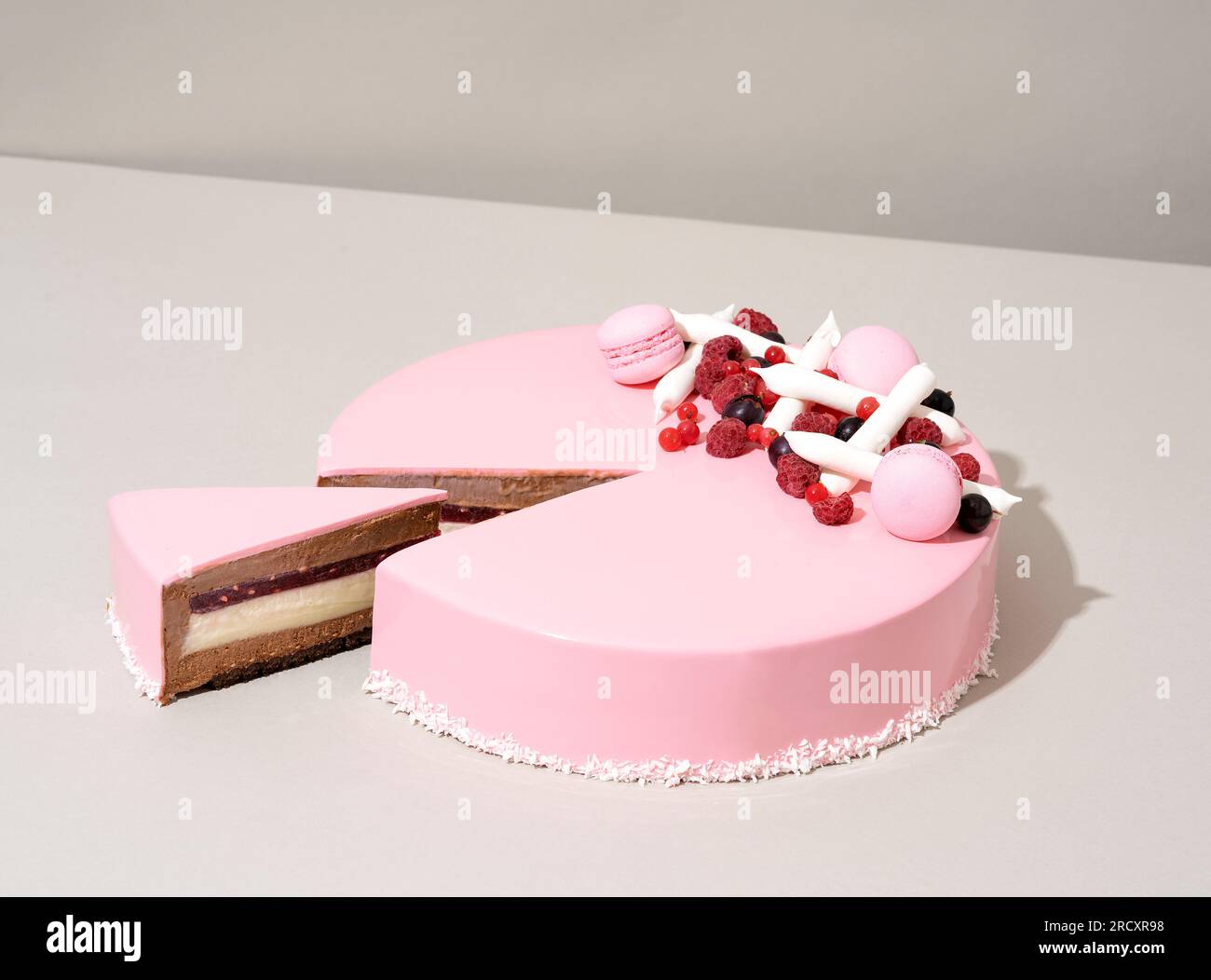 A close-up shot of a delectable cake featuring a raspberry and white chocolate topping Stock Photo