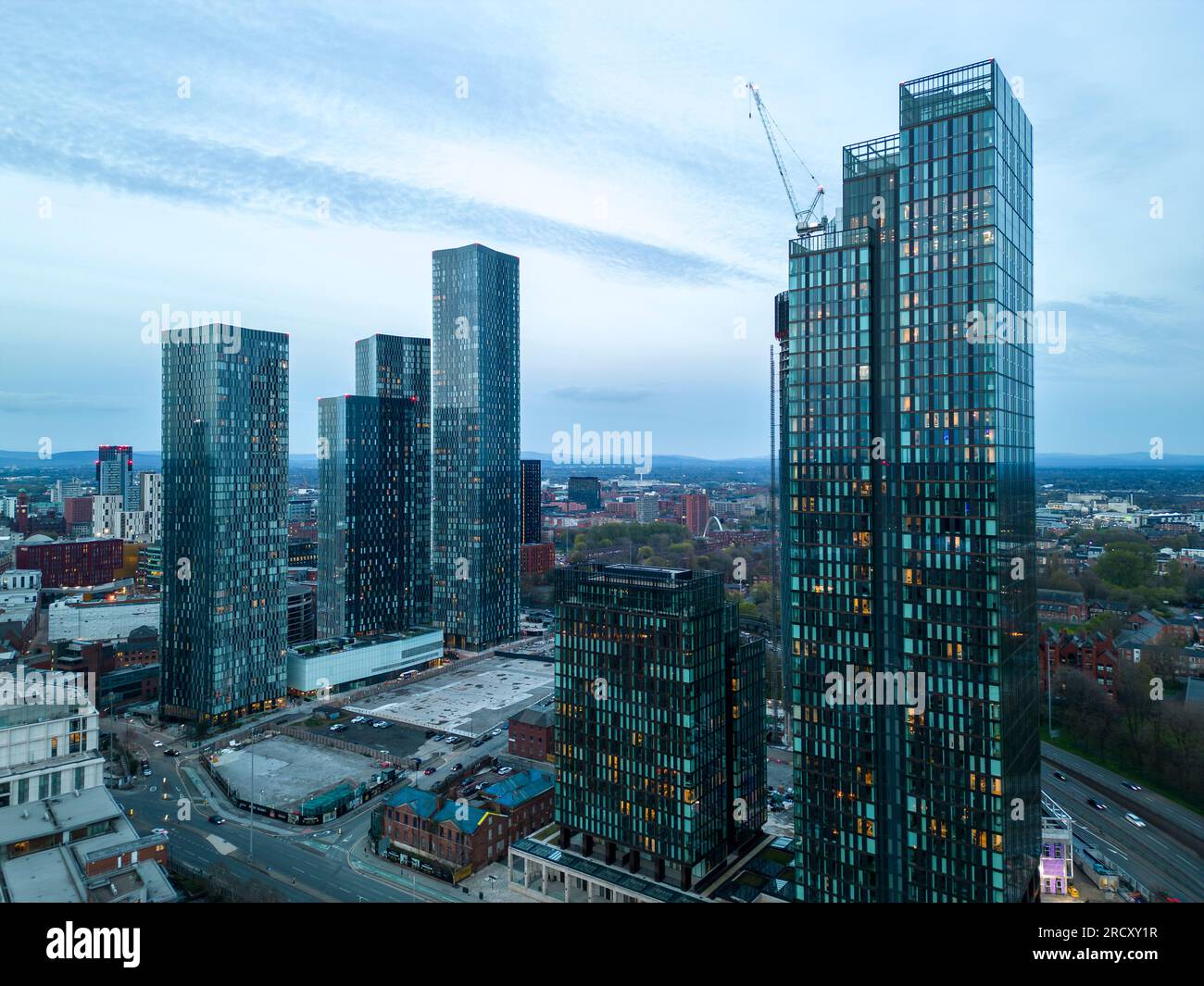 Deansgate Square towers and Elizabeth Tower at night, Manchester city centre, England Stock Photo