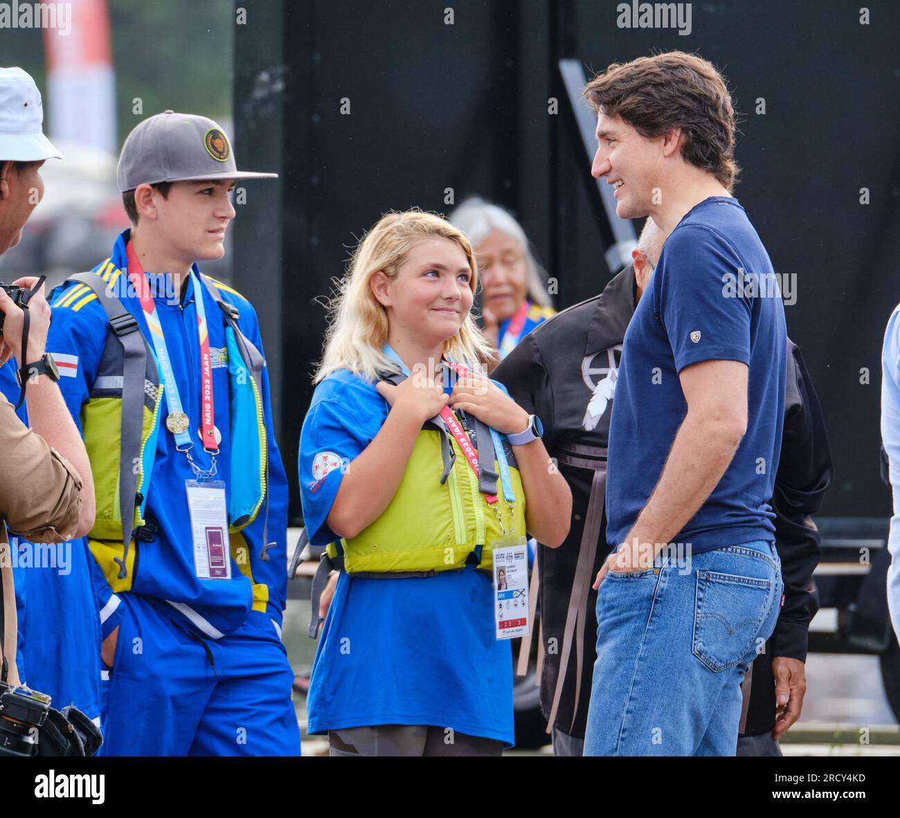 Dartmouth, Nova Scotia, Canada. July 17th, 2023. Canadian Prime Minister Justin Trudeau is greeted by Athletes of the Nova Scotia team as he rides an Indigenous Canoe at the opening of the Canoe competition at the North American Indigenous Games. Over 5000 athletes from 756 Indigenous Nations across Turtle Island will be competing until July 23rd with competitions in 16 sports within 21 venues across the area. Credit: meanderingemu/Alamy Live News Stock Photo