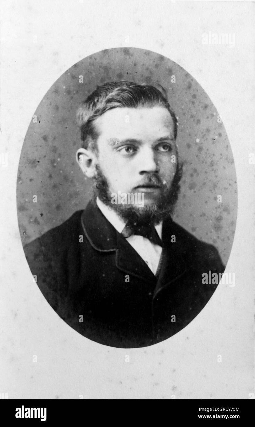 Head and shoulder portrait of a young man with a beard