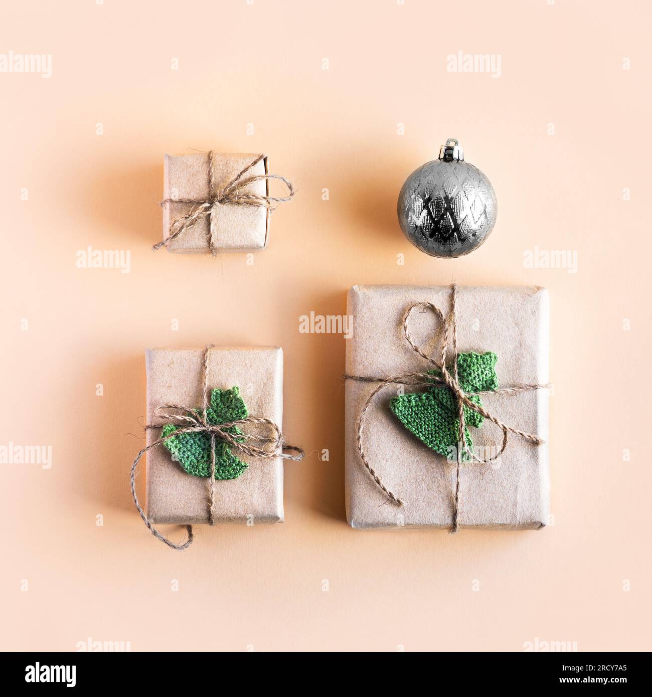 Christmas composition of a gift box in gray craft paper decorated with ...