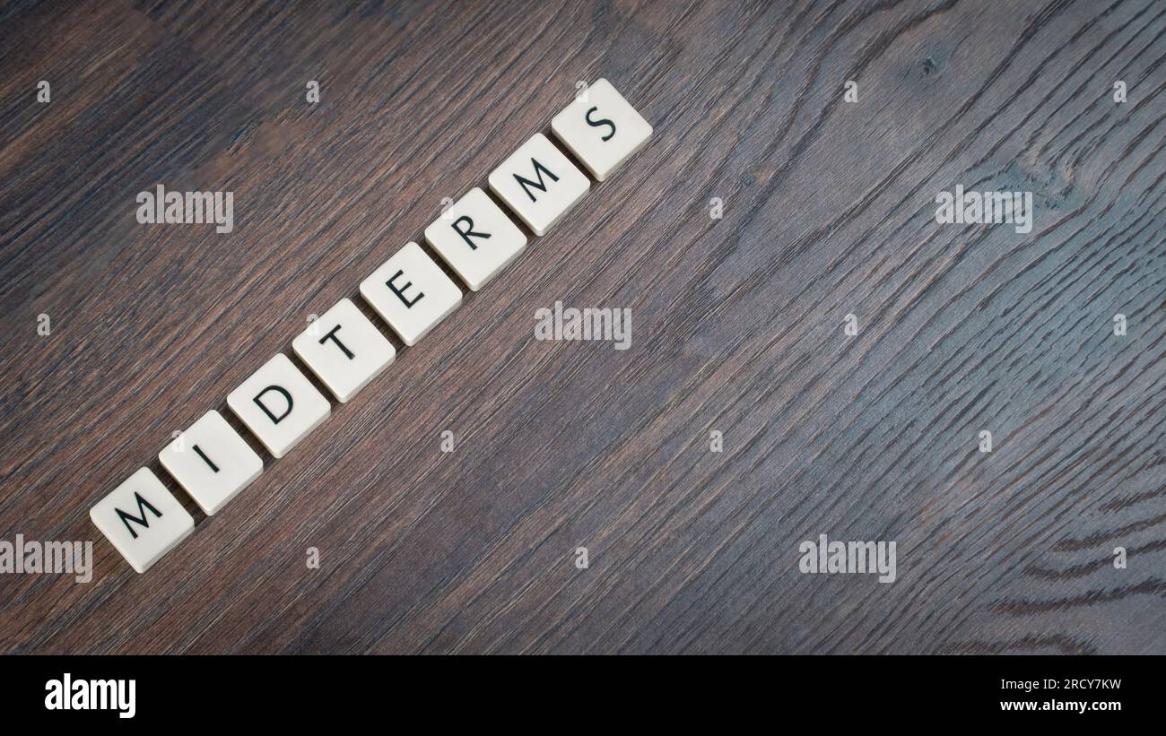 Back to school concept. Midterm exams week word on wooden desk ...