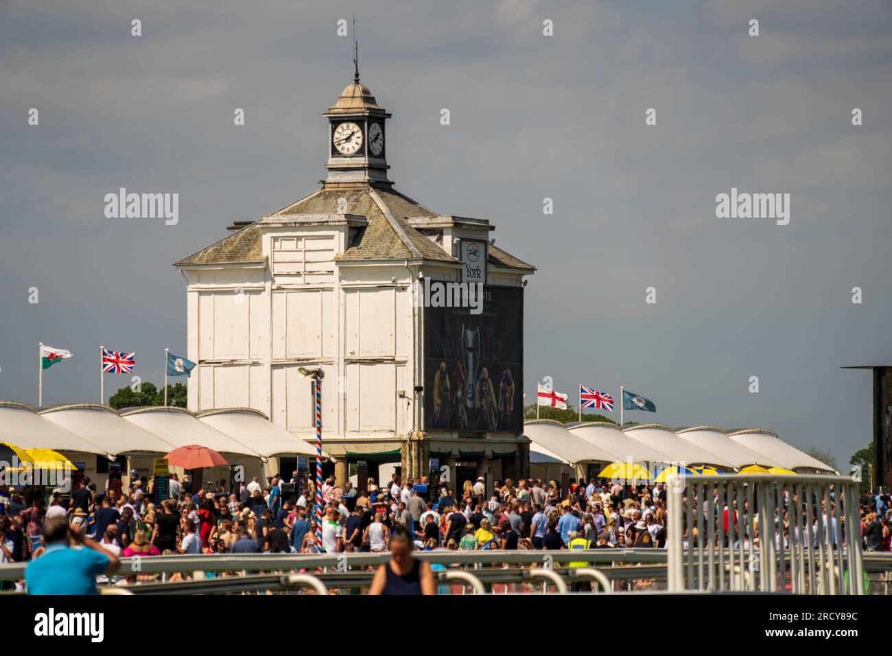 York Races. Crowds pack the Clocktower Enclosure at York Racecourse to enjoy the horse races, bet, picnic, eat, drink, laugh with friends and family. Stock Photo
