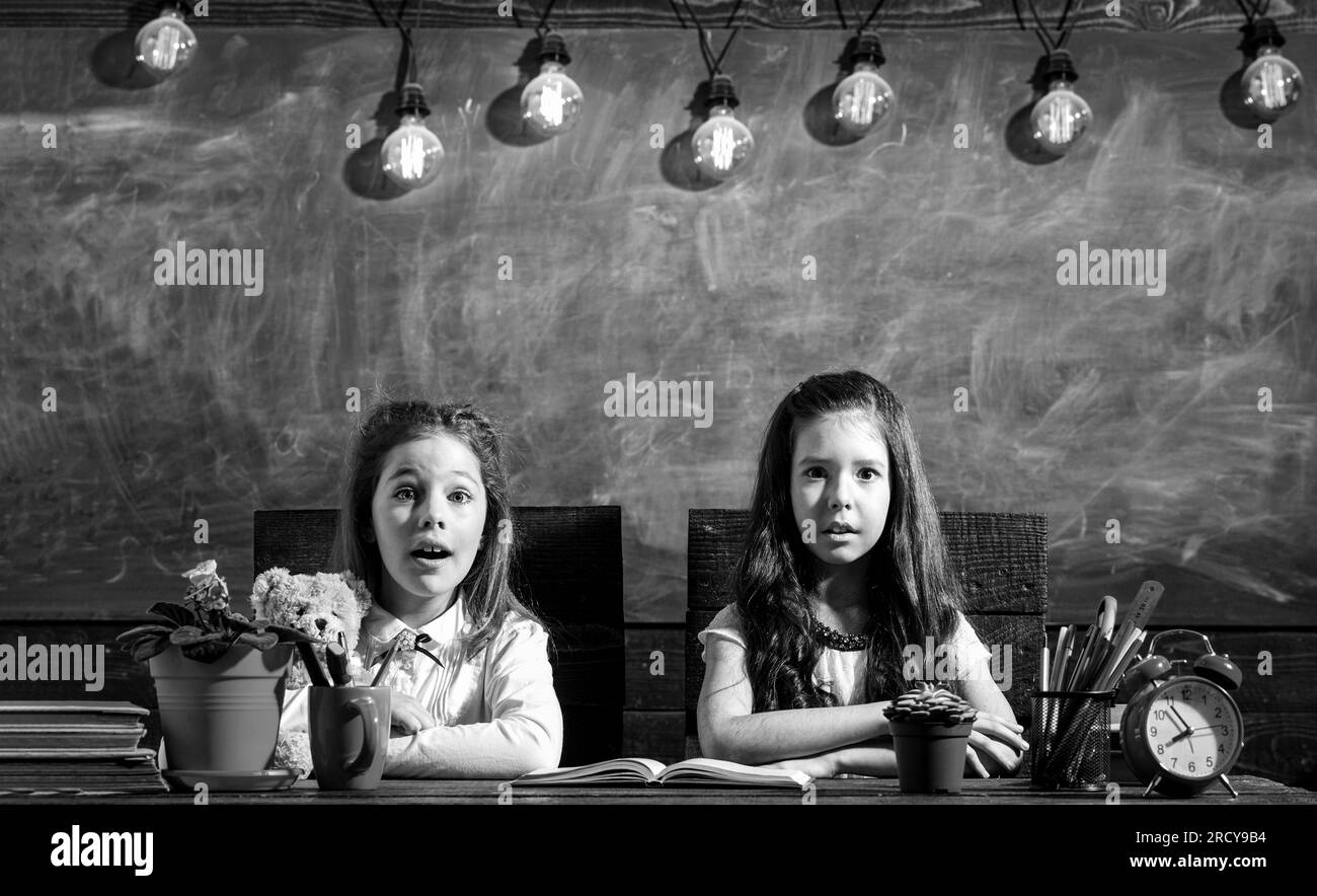 School lessons. Back to school and childhood concept. Education. School girls. Back to school. Little first graders. Black and white Stock Photo