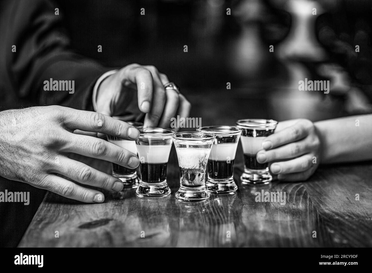 Group friends tequila shot glasses in bar. Male hands glasses of shot