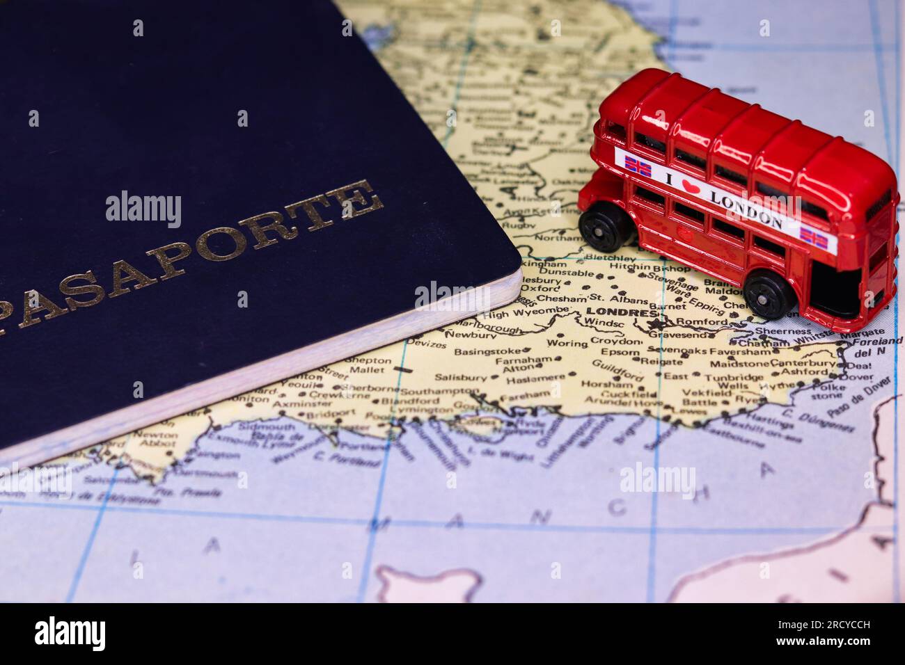 passport for travel to the uk on a map and a double decker bus Stock