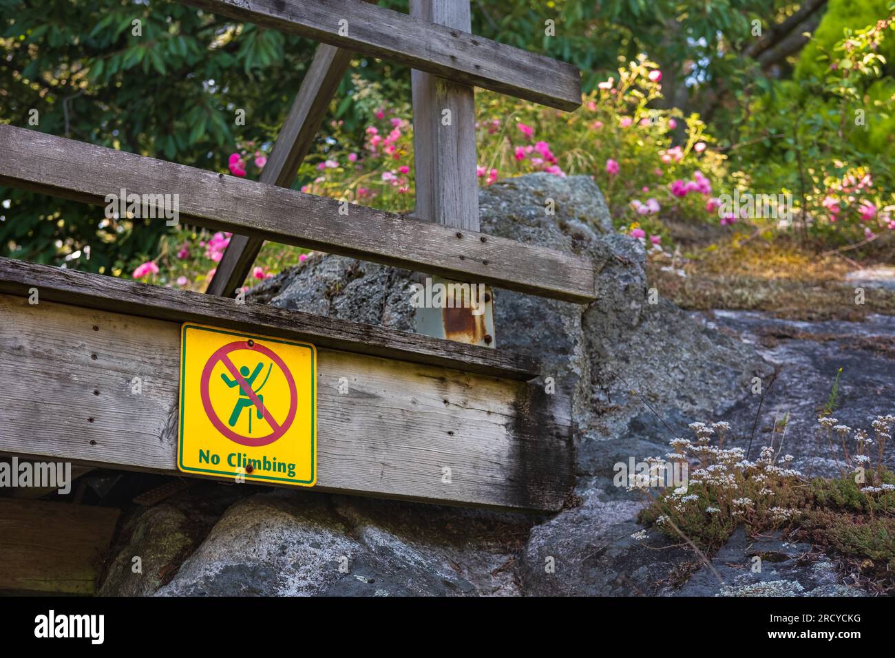 No climbing warning sign of danger in public park. Do no climb on rocks sign. Travel photo, nobody Stock Photo