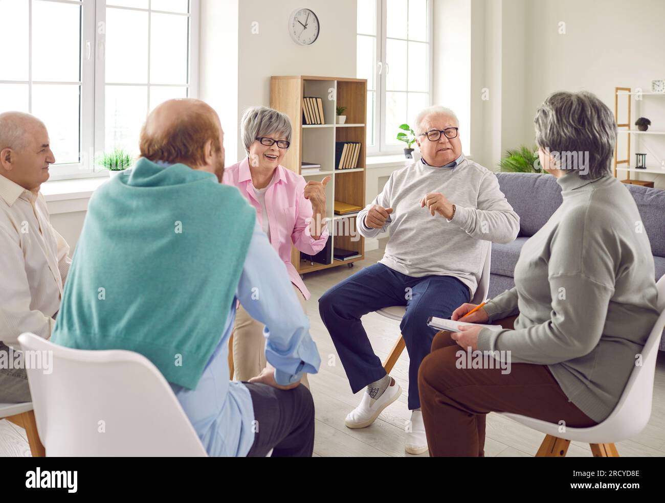 Senior man gets offended when friends at a retirement home make a joke about him Stock Photo