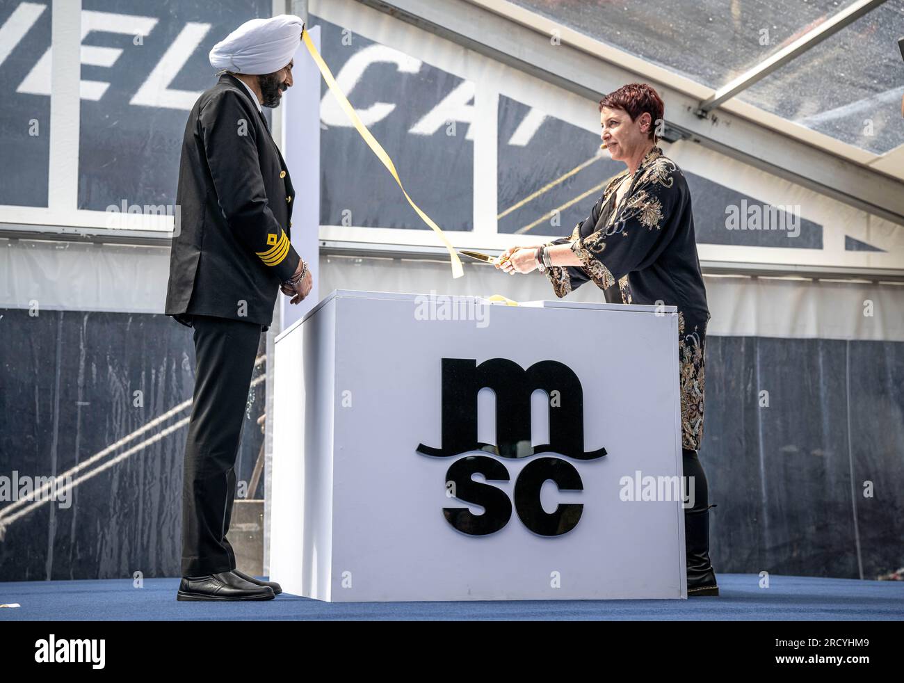 Bremerhaven, Germany. 17th July, 2023. Barinder Pal Singh (l), captain, and Cindy-Jo Cappellini, godmother and wife of the late MSC employee Michel Cappellini, christen the mega freighter 'MSC Michel Cappellini' built in China. The container ship is part of the MSC shipping company's latest generation of vessels. With a length of around 400 meters, a width of around 61 meters and a total capacity of 24,346 standard containers, it is one of the largest container ships ever built. Credit: Sina Schuldt/dpa/Alamy Live News Stock Photo