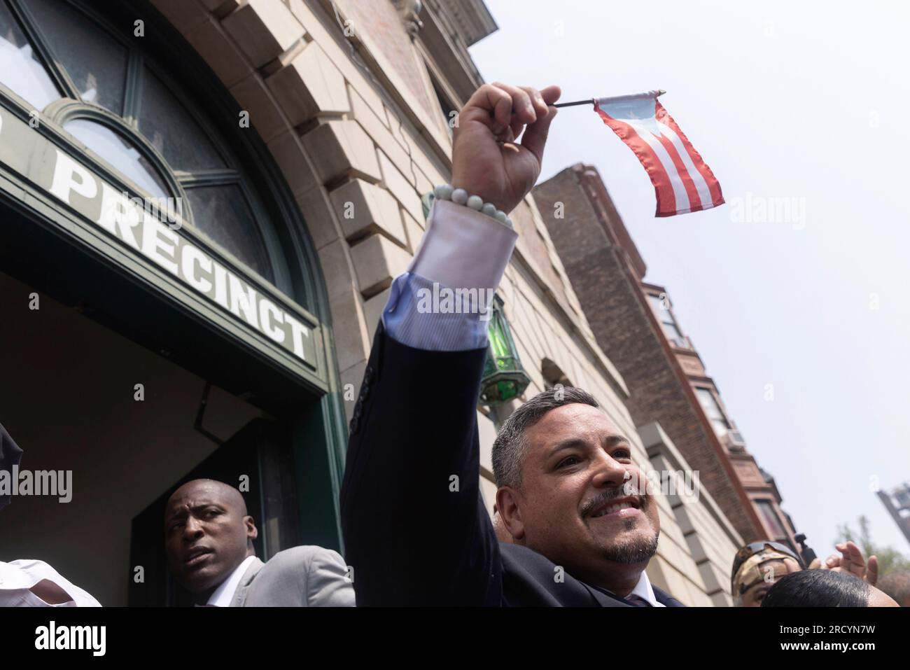 NYPD Police Commissioner Edward A. Caban holds a Puerto Rican flag