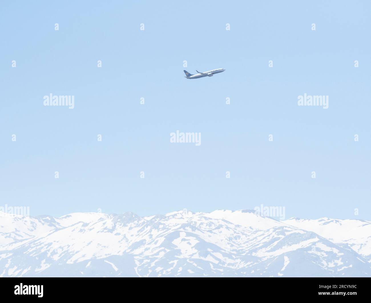 Jet Airplane flying above the White Mountains of Crete, Greece Stock Photo