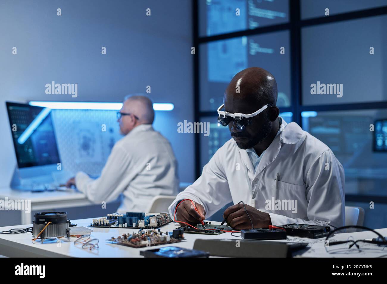 Engineers working with computer and computer details to develop ...