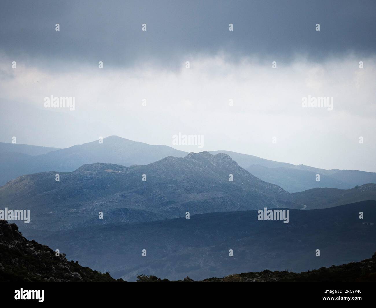 View showing stormy clouds over scrubland near Imbros Gorge, South West Crete Stock Photo