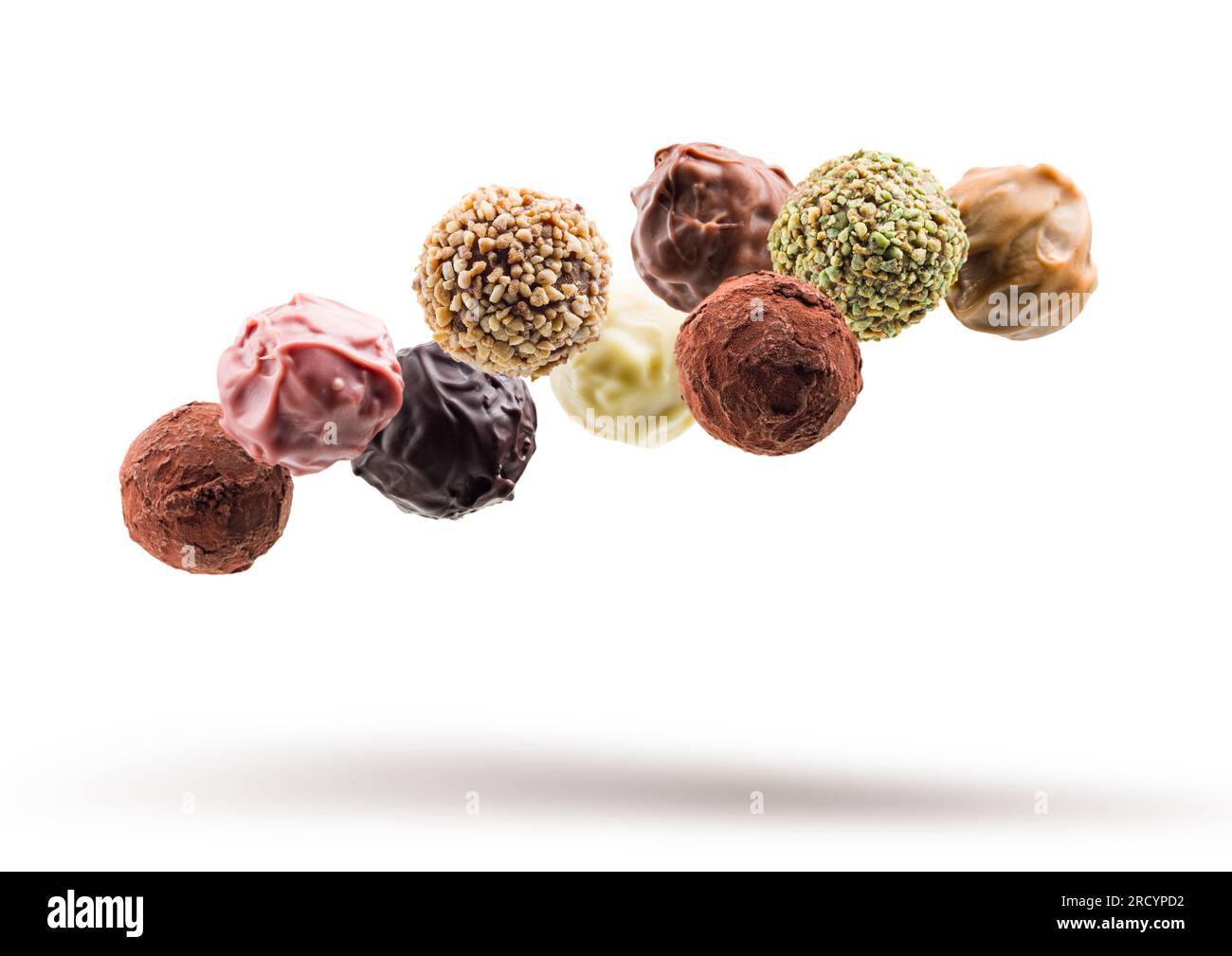 Assorted chocolate pralines floating on white background Stock Photo