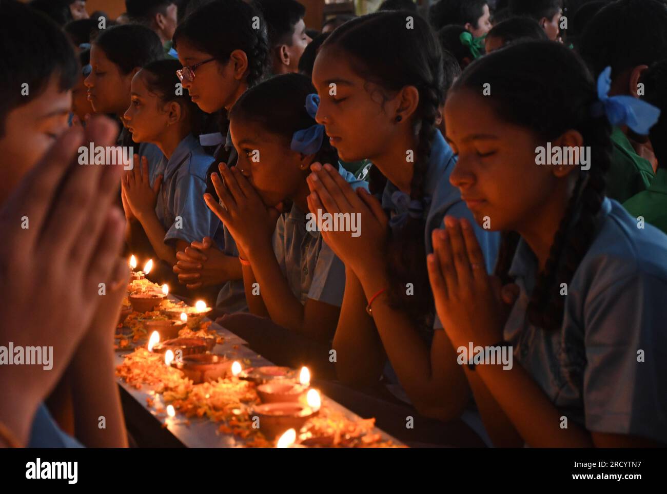 Students of Shivaji Shikshan Sanstha sitting in a line, light a diya ...