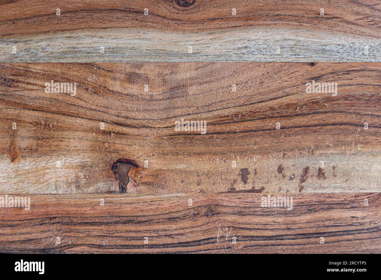 Texture of a cutting wooden board. hard transitions, saw cuts of knots. close up Stock Photo