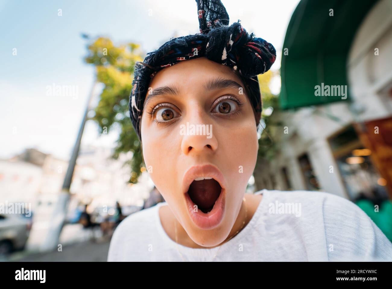 Shocked Walk In Close up of attractive young woman standing shocked, surprised outdoor ...