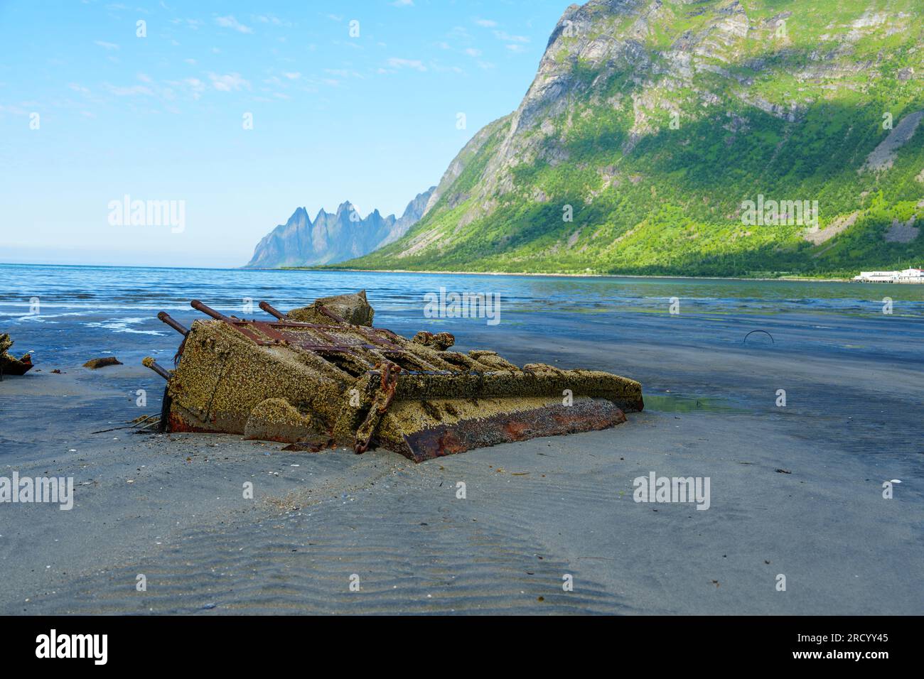 Remains of a sunken ship. wrecked cargo ship in Norway fjord. The weather is clear. Stock Photo