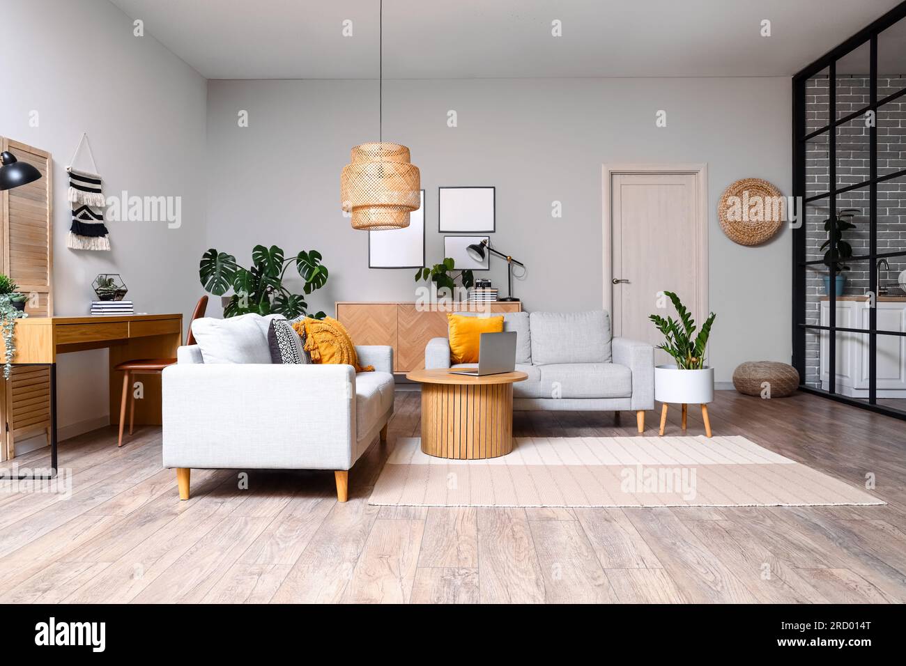 Interior of living room with green houseplants and sofas Stock Photo ...