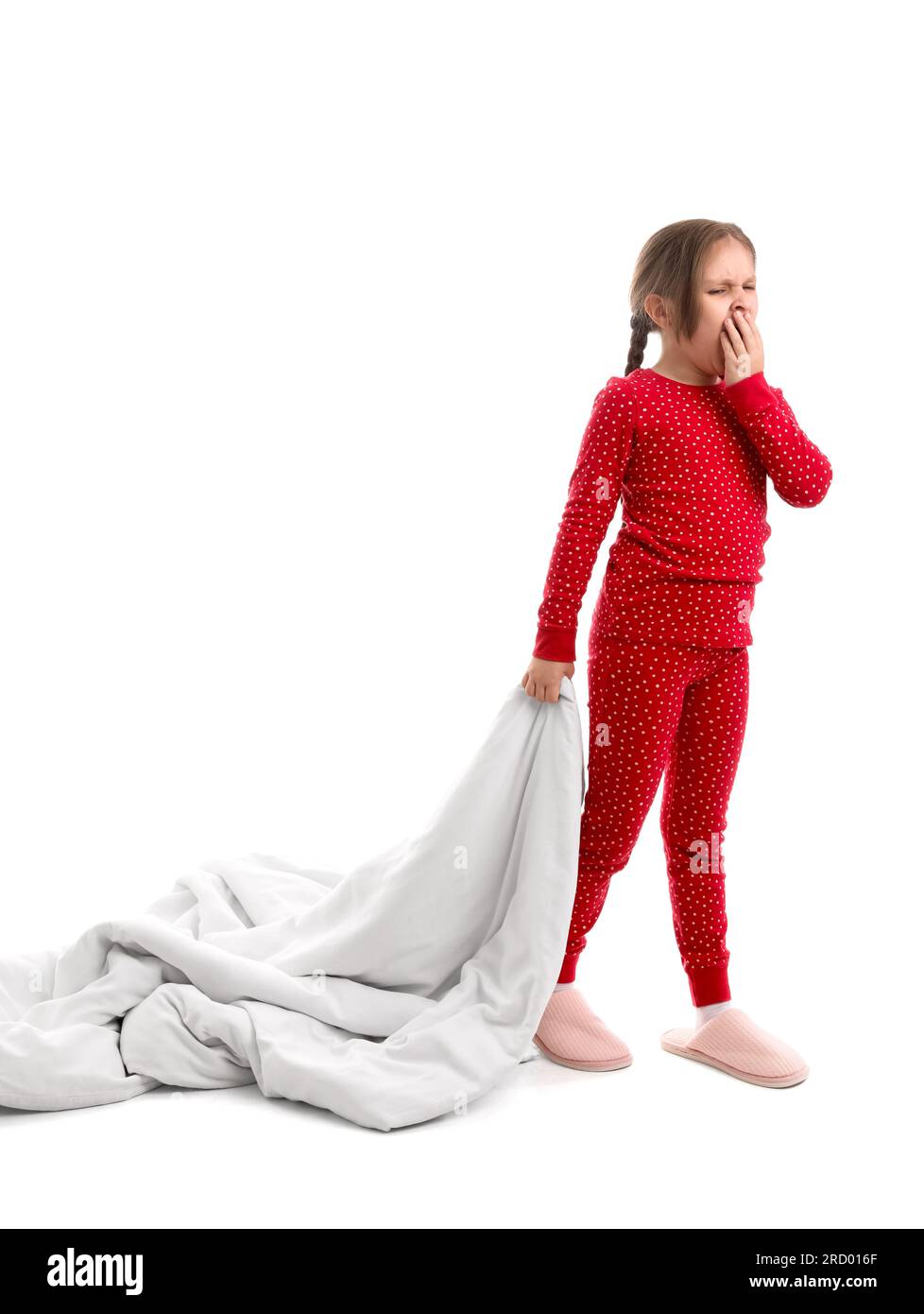 Sleepy little girl in pajamas with soft blanket on white background