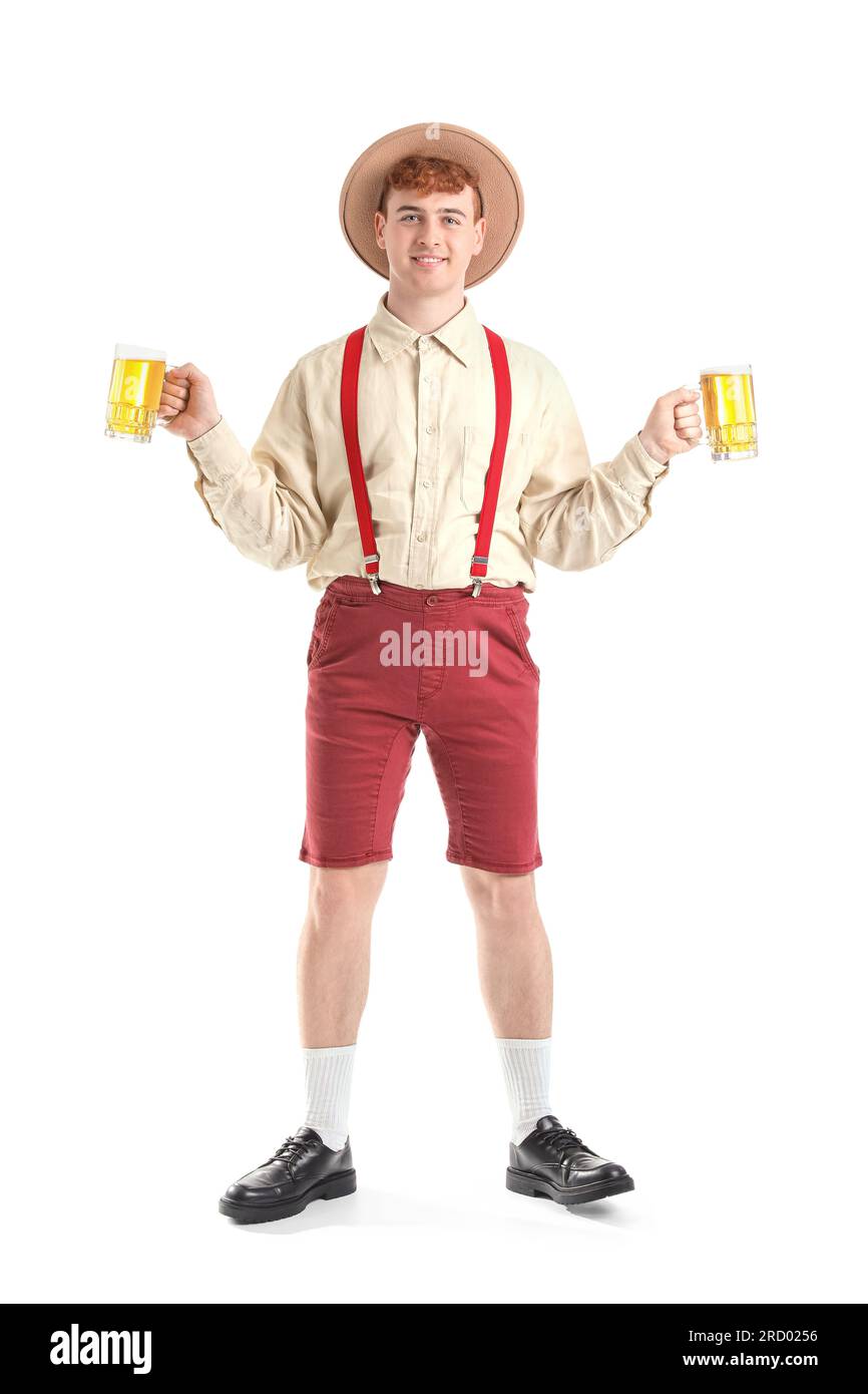Young man in traditional German clothes with beer on white background