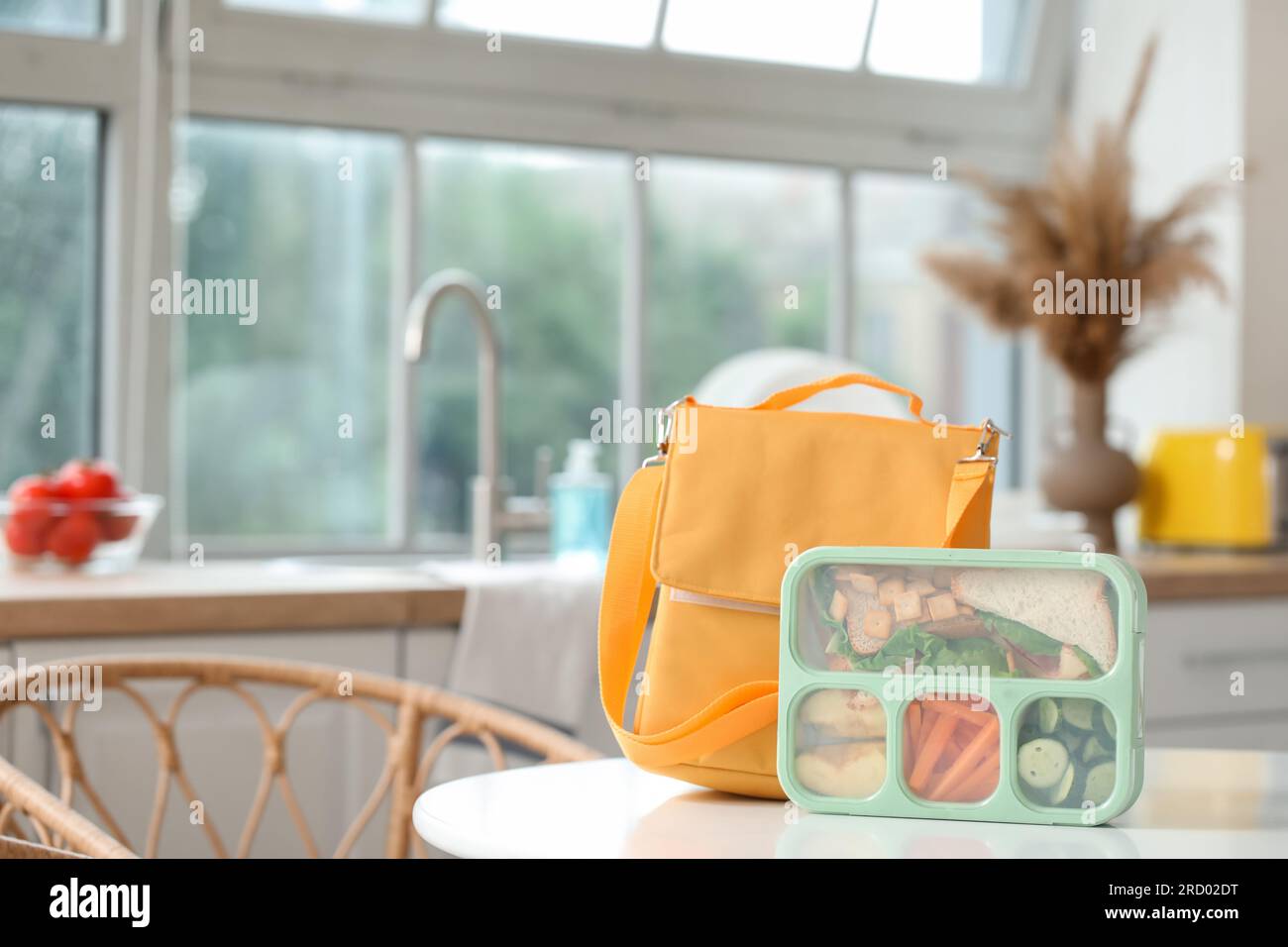 Backpack with school lunchbox on table in kitchen Stock Photo Alamy