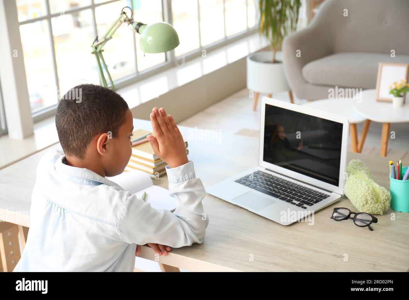 Little African-American boy studying Math online with laptop at home ...